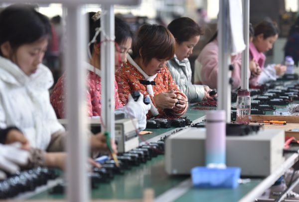 Workers at a loudspeaker production factory in Fuyang, China, 28 February 2022 (Photo: Reuters/Sheldon Cooper)