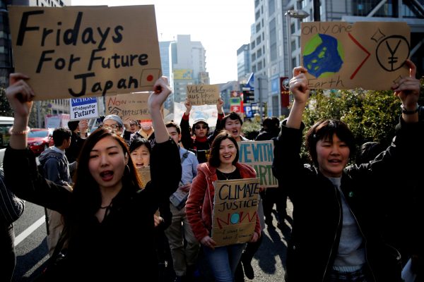 School students march with signs during the global students strike for action on climate change in Tokyo, Japan, 15 March 2019 (Photo: Reuters/Kim Kyung-hoon).