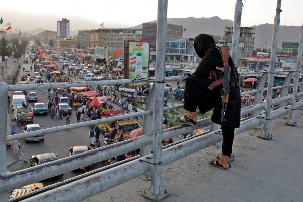 A Taliban fighter stands guard on a bridge in Kabul, Afghanistan, 6 August 2022. (Photo: Reuters/Ali Khara)