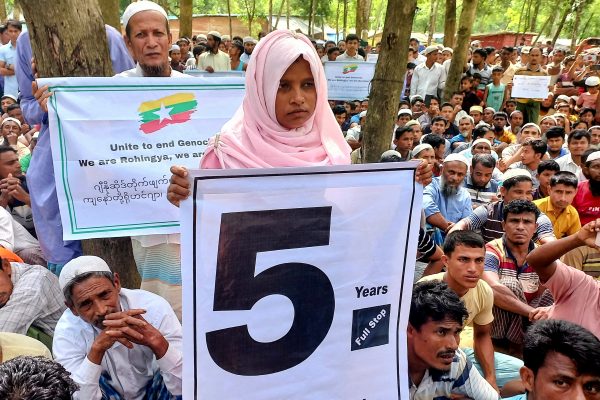 Rohingya refugees hold placards as they gather at the Kutupalong Refugee Camp to mark the fifth anniversary of their fleeing from neighbouring Myanmar to escape a military crackdown in 2017, in Cox's Bazar, Bangladesh, 25 August 2022 (Photo: Reuters/Rafiqur Rahman).