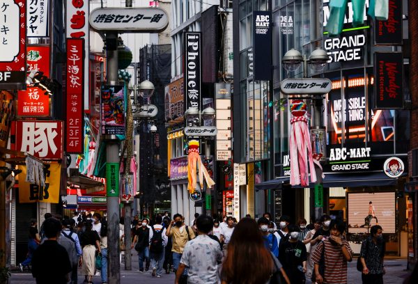 Passersby walk on the street at Shibuya shopping and amusement district, Tokyo, Japan, 28 July 2022 (Photo: Reuters/Issei Kato).