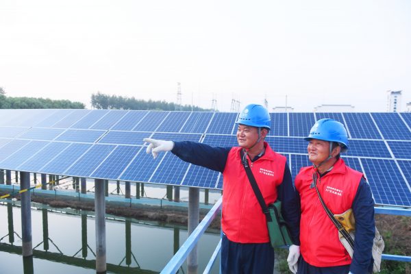 Staff from a green energy power station check solar panels, Tianchang county-level city, Chuzhou city, east China's Anhui province, 20 September 2020 (PHOTO: Song Weixing/Oriental Image via Reuters Connect).