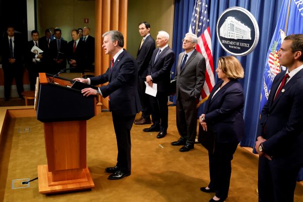 Federal Bureau of Investigation (FBI) Director Christopher Wray, with US Attorney General Merrick Garland, answers a reporter's question at a news conference announcing charges against two Chinese nationals for trying to obstruct the prosecution of China's Huawei Technologies Co Ltd, and four others with trying to spy for Beijing, at the Justice Department in Washington, US 24 October 2022 (Photo: Reuters/Jonathan Ernst).