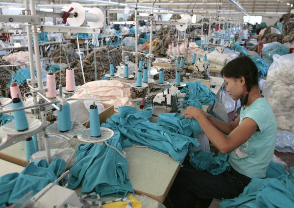 A Myanmar migrant works in a Taiwan-owned garment factory in the northwestern Thai town of Mae Sot 24 May 2007. Despite labour laws guaranteeing migrant workers basic rights such as a standard eight-hour working day, paid overtime and a minimum wage, the regulations are universally flouted, a Reuters investigation suggests (Photo: Reuters/Sukree Sukplang).