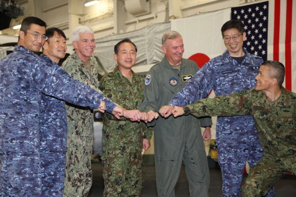 Members of the US and Japanese militaries show solidarity on the deck of Izumo, a general cargo vessel in the eastern water of Nansei Islands on 14 November 2022. (Photo: The Yomiuri Shimbun/Reuters)