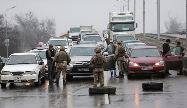 Kazakh law enforcement officers check vehicles on a road after mass protests triggered by fuel price increase erupted all over the country, Almaty, Kazakhstan, 8 January 2022 (Photo: Reuters/Pavel Mikheyev).