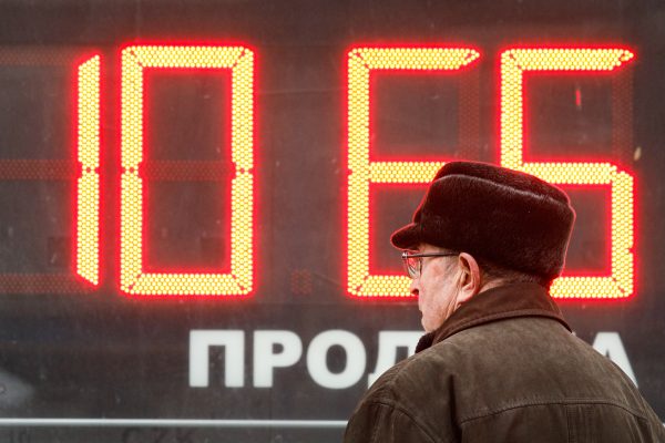 A man looks at the exchange rate at the exchange office, St. Petersburg, Russia, 28 February 2022 (PHOTO: Valya Egorshin/NurPhoto via Reuters Connect)
