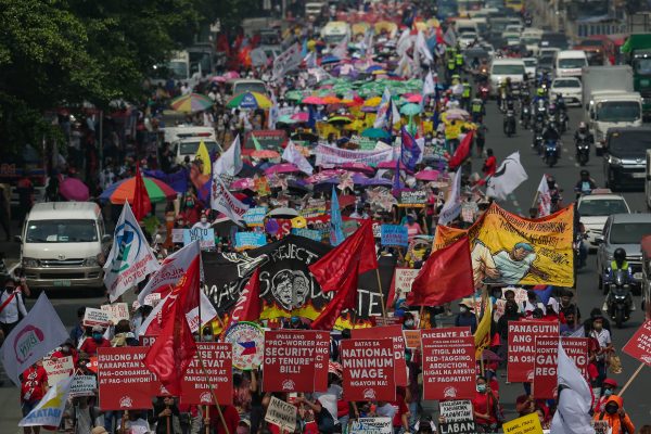 Activists march in protest along a highway in Quezon City, north of Manila on 25 July 2022. The son and namesake of the former dictator will deliver his first State of the Nation Address as the newly elected president of the country (Photo: Reuters/George Calvelo/NurPhoto).