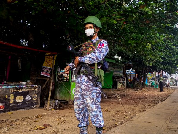 An armed navy soldier stands guard at the roadside during the visit of theÂ Myanmar junta leader Min Aung Hlaing to Thanlyin township, on the outskirts of Yangon onÂ December 24, 2022. (Photo by STR/NurPhoto)