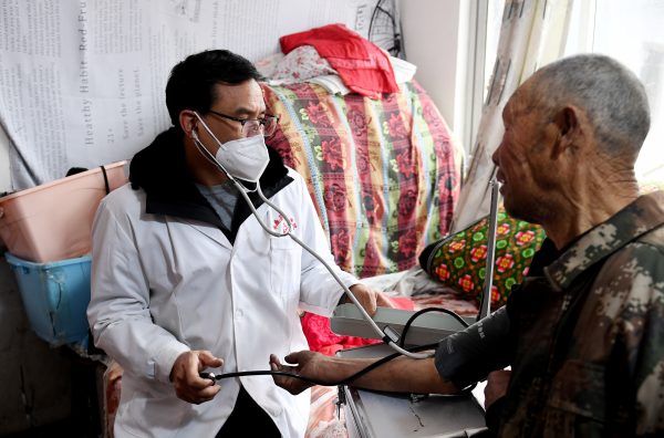 A village doctor treats villagers in Chengziling village of Zhangjiakou City, North China's Hebei Province on 16 January 2023. (Photo: Sipa USA/Reuters)