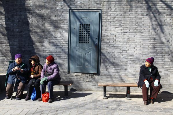 Senior citizens sit on benches in a street in Beijing, China, 11 March 2012 (Photo: Reuters).