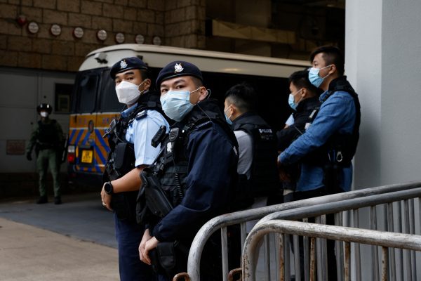 Armed police stand guard as they escort a prison van that is believed to carry media mogul Jimmy Lai, founder of Apple Daily, to the High Court in Hong Kong, China, 1 December 2022 (Photo: Reuters/Tyrone Siu).