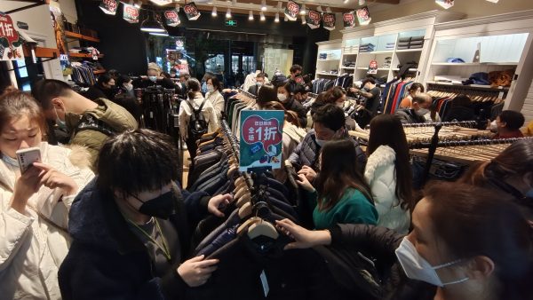 People spend money during the Double 12 Shopping Festival promotion at a department store in Shanghai, China, 10 December 2022 (Photo: CFOTO/Sipa USA via Reuters).