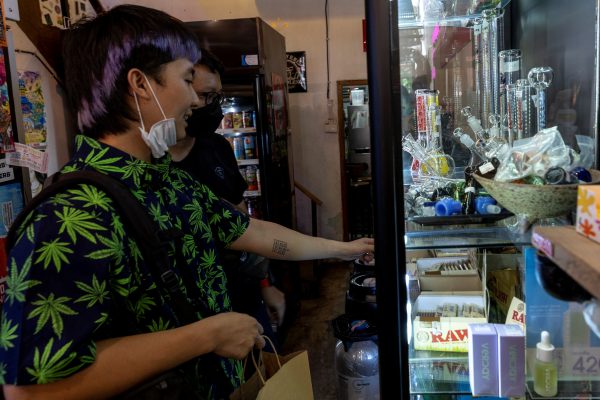 Customers shop inside the Highland Cafe on the first day of removing cannabis from the narcotics list under Thai law in Bangkok, Thailand, 9 June 2022 (Photo: Reuters/Athit Perawongmetha).