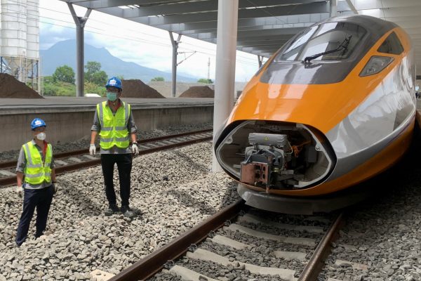 Workers stand beside an Electric Multiple Unit high-speed train for a rail link project part of China's Belt and Road Initiative, at Tegalluar train depot in Bandung, West Java province, Indonesia, 13 October 2022 (Photo: Reuters/Yuddy Cahya Budiman).