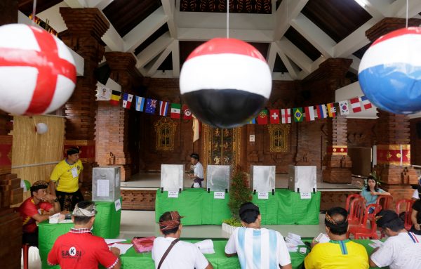 Balinese vote in local elections at a polling station decorated in a World Cup theme in Badung Regency, on the Bali, Indonesia, 27 June 2018 (Photo: Reuters/Johannes P. Christo).