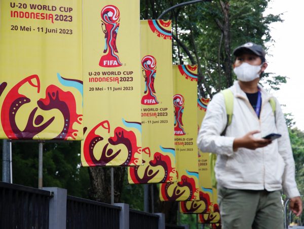 A man walks past FIFA U-20 World Cup banners outside Indonesia's football federation (PSSI) office, after the country was dropped as host of the under-20 soccer World Cup, following outrage among politicians in the predominantly Muslim country about Israel's participation, in Jakarta, Indonesia, 30 March 30 2023 (Photo: Reuters/Willy Kurniawan)