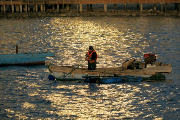 A fisherman drives a fishing boat to the sea off Changdao in Yantai, China, 1 April 2023 (Photo: Reuters/Sipa USA).