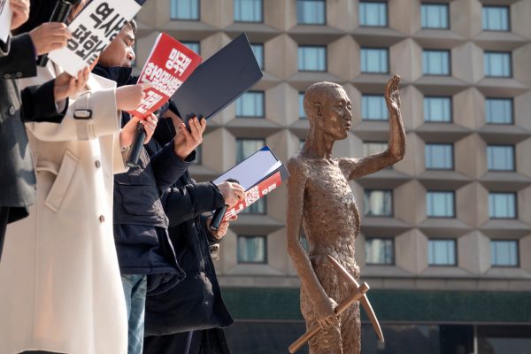 Anti-Japan protestors demonstrating in front of a statue of a World War 2 Korean slave worker, Seoul, South Korea, 18 March 2023 (Photo: Reuters/Lee Jae-Won).