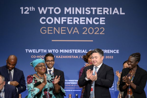 World Trade Organization Director-General Ngozi Okonjo-Iweala claps next to conference chair Timur Suleimenov after a closing session of a World Trade Organization Ministerial Conference at the WTO headquarters in Geneva, Switzerland, 17 June 2022 (Photo: Reuters/Fabrice Coffrini/Pool).
