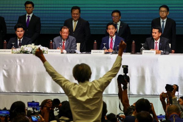 A citizen journalist gestures as Move Forward Party leader Pita Limjaroenrat holds a press conference to announce the party's agreement with coalition partners in Bangkok, Thailand, 22 May 2023 (Photo: Reuters/Athit Perawongmetha).