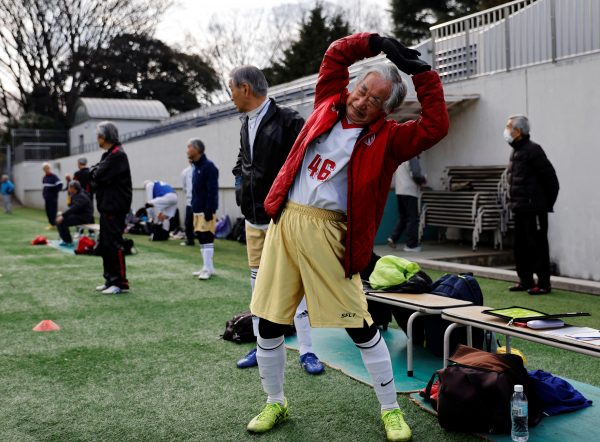 Kozo Ishida, 82, stretches before a pre-season practice match for the upcoming SFL (Soccer For Life) 80 league opening matches in Tokyo, Japan, 8 February 2023 (Photo: Reuters/Kim Kyung-Hoon).
