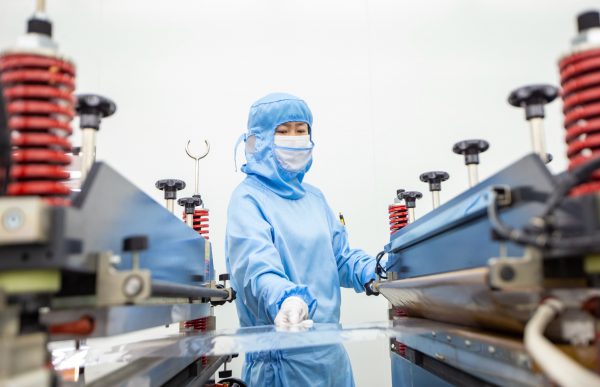 A worker produces semiconductor packaging materials for domestic and international markets at the Class 100 clean packaging workshop in Hai 'an, Jiangsu province, China, 27 February 2023 (Photo: Reuters/CFOTO/Sipa USA).