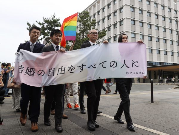 Plaintiffs with a banner for a same-sex marriage lawsuit at the Fukuoka District Court, Fukuoka City, Japan, 8 June 2023 (Photo: Reuters/The Yomiuri Shimbun).