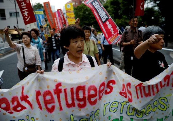 Protesters shout slogans during a march to observe World Refugee Day in Tokyo, Japan, 20 June 2019 (Photo: Reuters/Kim Kyung-Hoon).