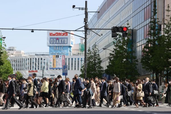 Commuters walk near Shinjuku Station, Tokyo, Japan, 26 April 2021 (Photo: Reuters/The Yomiuri Shimbun).