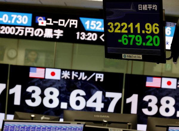 A monitor displaying the Nikkei index is seen in front of monitors showing the current Japanese Yen exchange rate against the U.S. dollar at a foreign exchange trading company in Tokyo, Japan, 28 July 2023. (Photo: Reuters/Kim Kyung-Hoon)