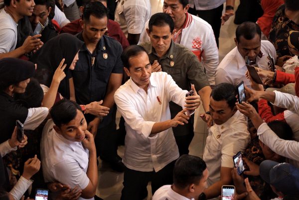 Indonesia's President Joko Widodo takes selfies with supporters following meet forum Jokowi supporters in Bogor, West Java, Indonesia, 16 September 2023 (Photo: Ryan Maulana/Reuters).