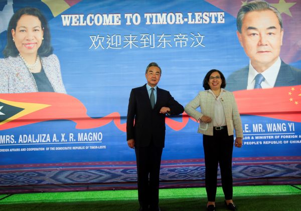 Chinese Foreign Minister Wang Yi bumps elbows with East Timor's Minister of Foreign Affairs and Cooperation Adaljiza Magno during their meeting in Dili, East Timor, 3 June 2022. (Photo:REUTERS/Lirio da Fonseca)