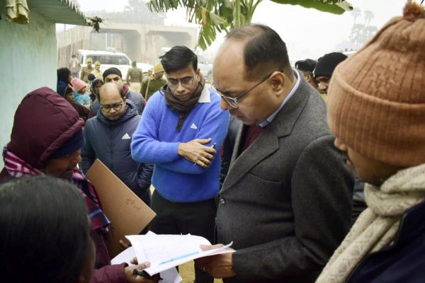 Patna District Magistrate Chandrashekhar Singh with enumerator staff receive information from residents during the first phase of much-hyped caste-based census in Bihar state on 9 January 2023 in Patna, India (Photo: Reuters/Santosh Kumar/Hindustan Times/Sipa USA).