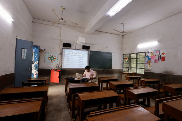 A teacher conducts online classes in an empty classroom after primary schools were ordered shut by the Delhi government for Friday and Saturday as the air quality index (AQI) plummeted, on a smoggy morning in New Delhi, India, 3 November 2023 (Photo: Reuters/Anushree Fadnavis).