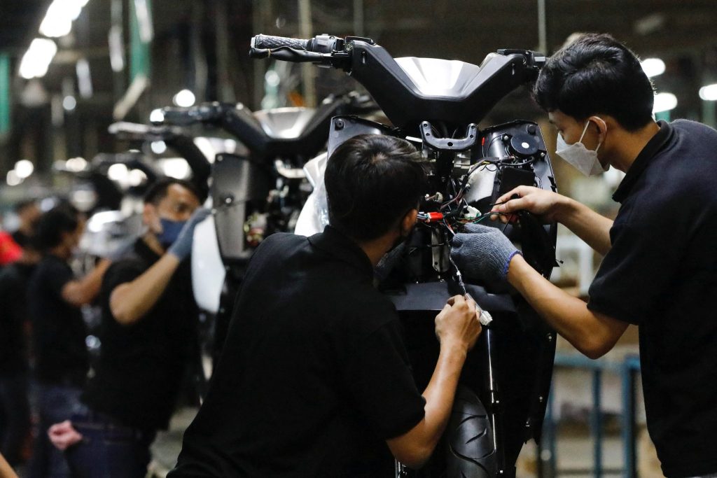 Employees work at the assembly line of an electric motorcycle at the United E-Motor factory in Bogor, near Jakarta, Indonesia, 25 August 2022 (Photo: Reuters/Ajeng Dinar Ulfiana).