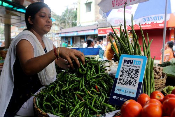 A vegetable vendor waits for customers displaying a barcode for Paytm, an Indian cellphone-based digital payment platform, Kolkata, India, 4 July 2023 (Photo: Reuters/Debajyoti Chakraborty).