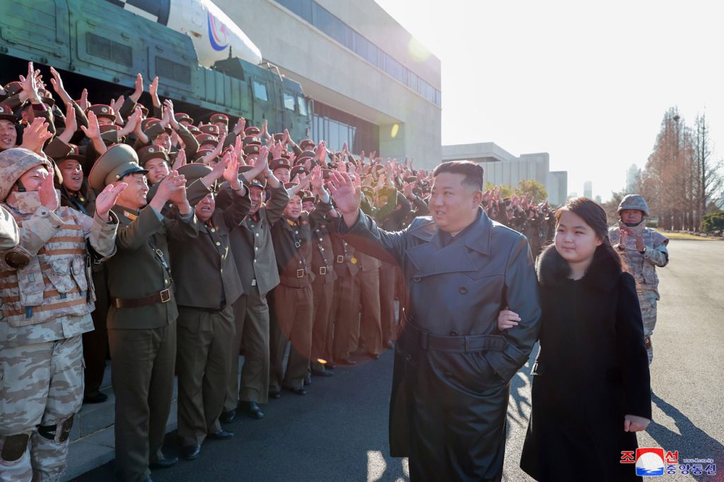 North Korean President Kim Jong-un, accompanied by his daughter Kim Ju-ae, attends a meeting and photo session with the officials, scientists, technicians and soldiers who contributed to the successful test launch of the DPRK's strongest war deterrent in history, 27 November 2022 (Photo: Reuters/KCNA).