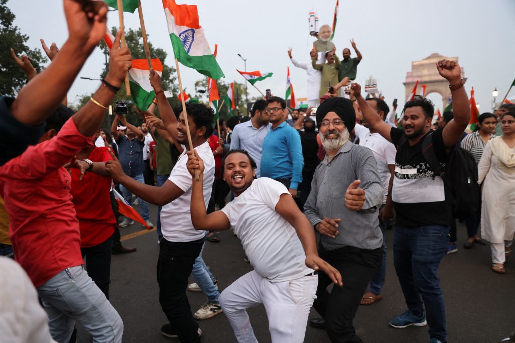 People and supporters of India's ruling Bharatiya Janata Party (BJP) celebrate the Chandrayaan-3 spacecraft's landing on the moon at an event organised near India Gate in New Delhi, India, 23 August 2023 (Photo: Reuters/Anushree Fadnavis).