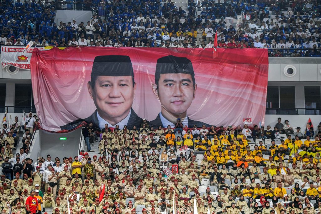 A giant banner depicting Indonesia's defence minister and presidential candidate, Prabowo Subianto, and his running mate, Gibran Rakabuming Raka, who is the eldest son of Indonesian President Joko Widodo and Surakarta's Mayor, is seen among the supporters, before they register themselves for next year's presidential election, in Jakarta, Indonesia, 25 October 2023 (Photo: Reuters/Antara Foto/Galih Pradipta).