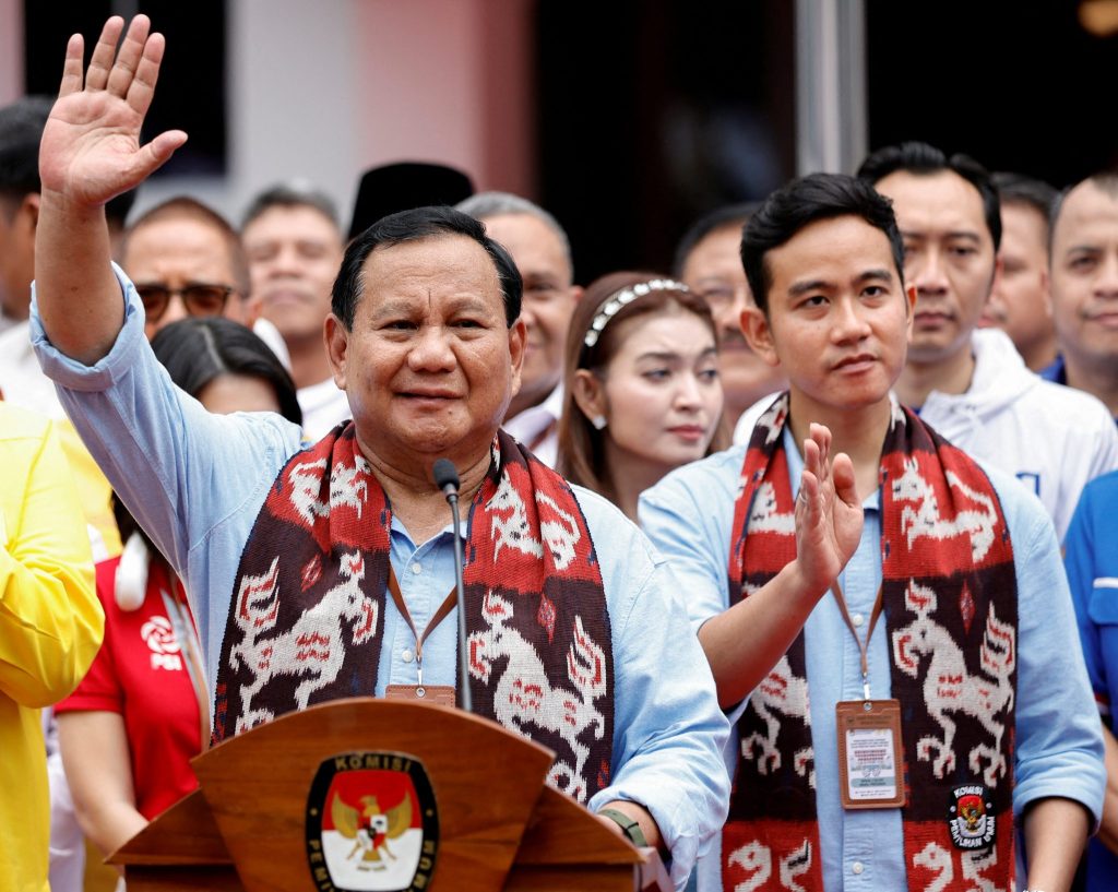 Indonesia's defence minister and presidential candidate, Prabowo Subianto, along with his running mate, Gibran Rakabuming Raka, who is the eldest son of Indonesian President Joko Widodo and Surakarta's Mayor, wave after registering themselves for next year's presidential election, at the election commission headquarters in Jakarta, Indonesia, 25 October 2023 (Photo: Reuters/Willy Kurniawan).
