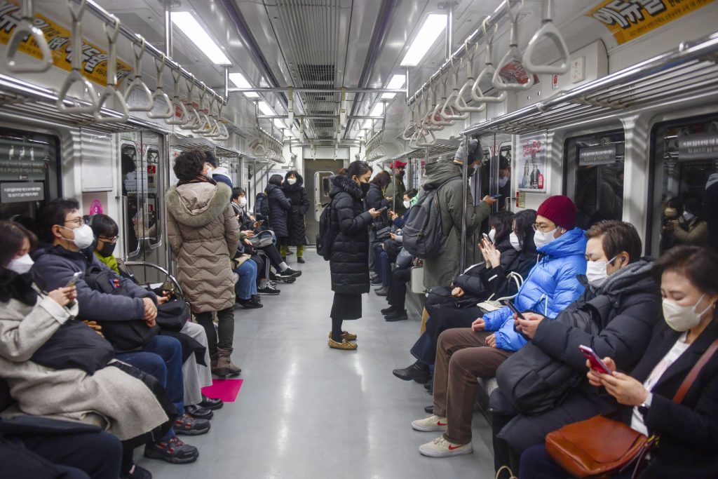 People wearing face masks ride a subway train in Seoul, South Korea on 30 January 2023 (Photo: Kyodo via Reuters).