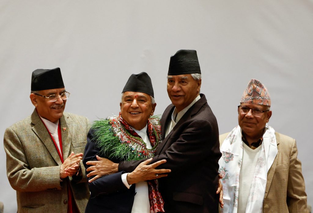 Newly-elected President Ram Chandra Paudel is greeted by the former Prime Minister Sher Bahadur Deuba along with Nepal's Prime Minister Pushpa Kamal Dahal (L), also known as Prachanda, and former Prime Minister Madhav Kumar Nepal, after being elected as the third president of Nepal at the Parliament in Kathmandu, Nepal, 9 March 2023 (Photo: Reuters/Navesh Chitrakar).