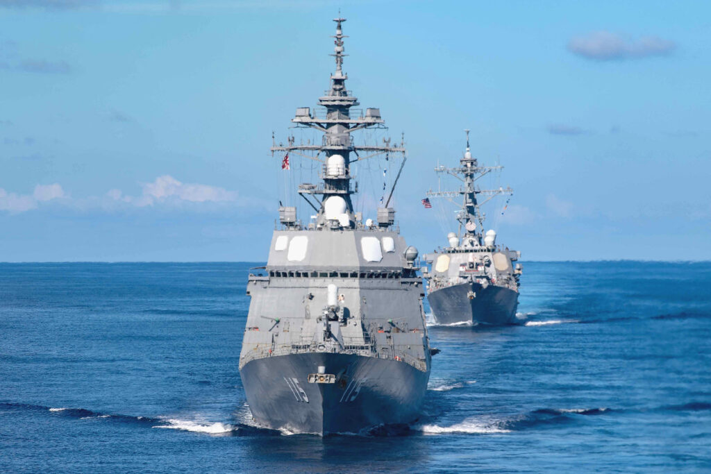 The Arleigh Burke-class guided-missile destroyer USS Milius (DDG 69), rear and the Japan Maritime Self-Defense Force (JMSDF) Akizuki-class destroyer JS Akizuki (DD 115) transit the South China Sea, 19 October 2021 (Photo: Christine Montgomery/ US Navy via Reuters).