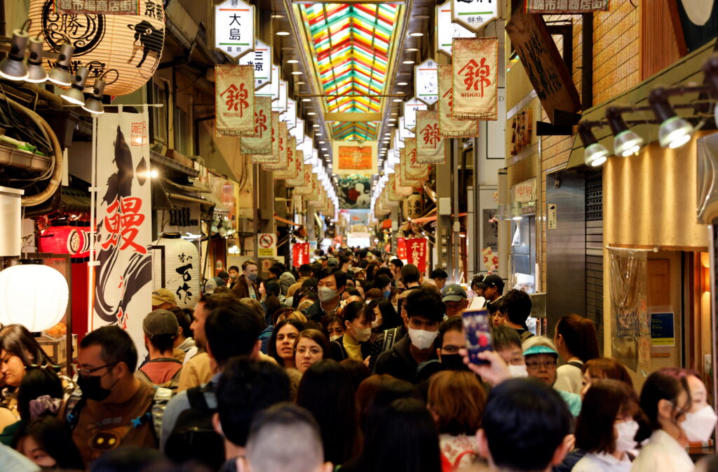 A crowd of tourists walk at Nishiki Market in Kyoto, Japan, 29 March 2023. (Photo: Reuters/Issei Kato).