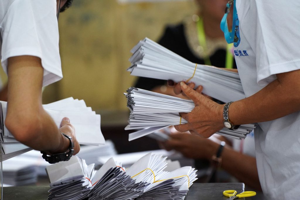 Election officials count ballots at a polling station on the day of Cambodia's general election, in Phnom Penh, Cambodia, 23 July 2023 (Photo: Cindy Liu/Reuters).
