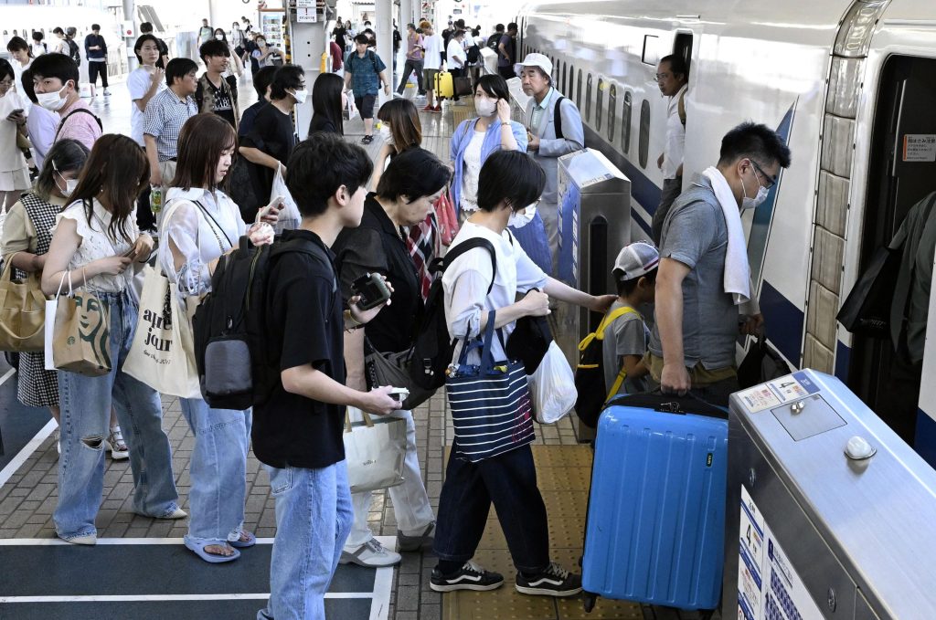 Passengers fill a shinkansen bullet train platform in Osaka as people head to and return from rural holiday destinations, 13 August 2023 (Photo: Reuters/Kyodo).