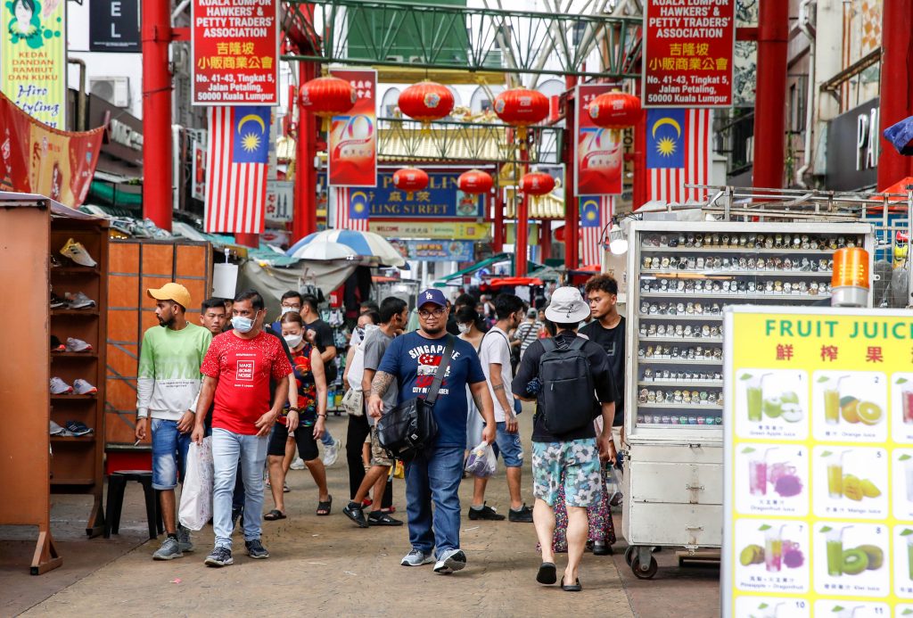People walk along the China Town shopping district in Kuala Lumpur, Malaysia, 21 December 2023 (Photo: Wong Fok Loy/SOPA Images via Reuters).
