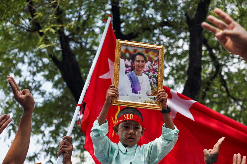 A protester holds up a portrait of Aung San Suu Kyi during a demonstration to mark the third anniversary of Myanmar’s 2021 military coup, outside of the United Nations office in Bangkok, Thailand, 1 February 2024. (Photo: Reuters/Chalinee Thirasupa).
