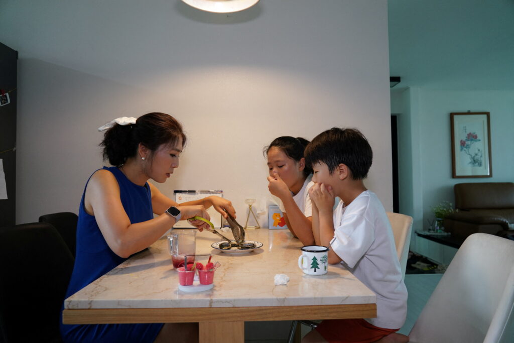 Lee Young-Min, 38, has a seafood meal with her children, Seongnam, South Korea, 28 June 2023 (Photo: Reuters/Daewoung Kim).